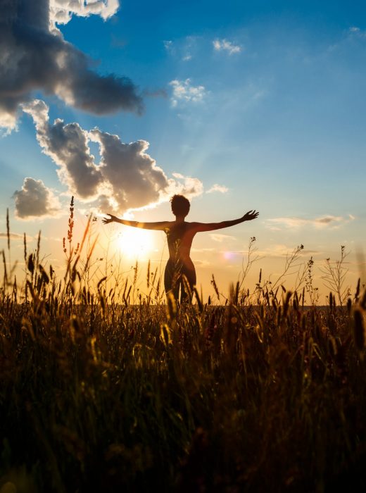 Silhouette of sportive girl practicing yoga in field at sunrise. Silhouette of young beautiful sportive girl practicing yoga in field at sunrise.